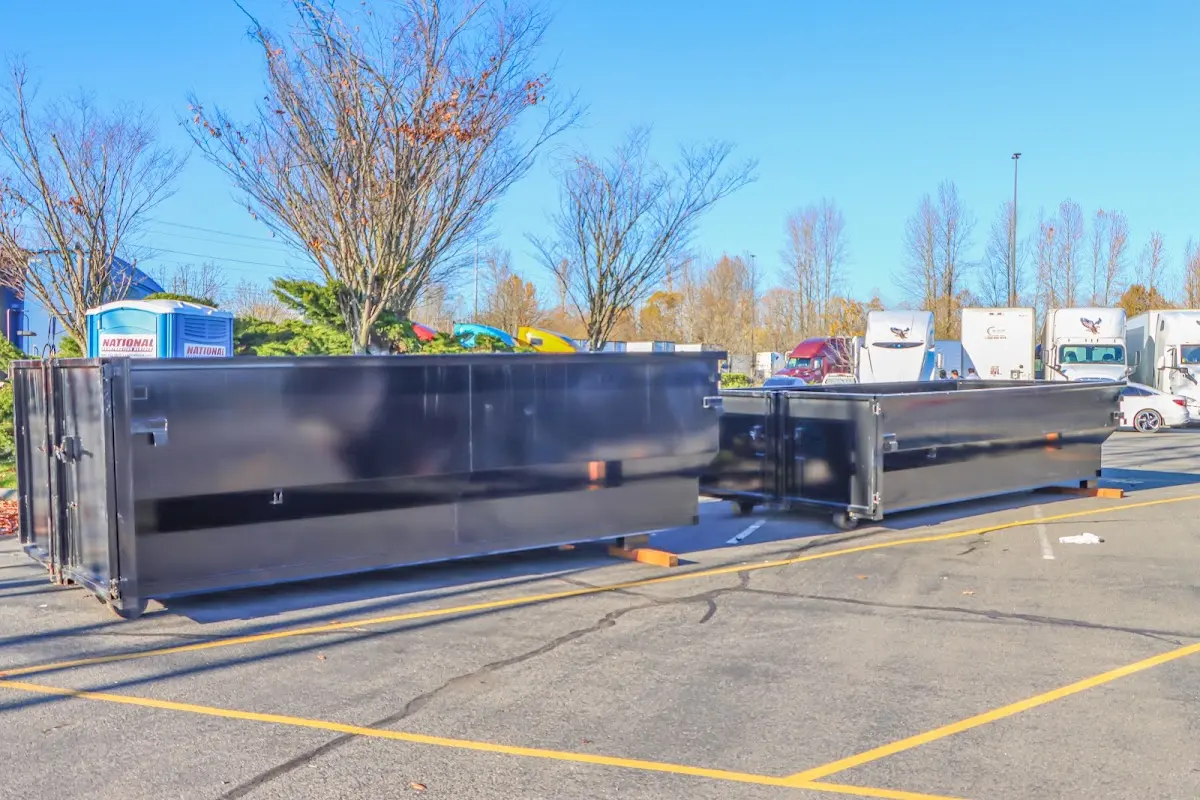 Professional dumpster rental service with roll-off container on residential driveway in Wolf Trap
